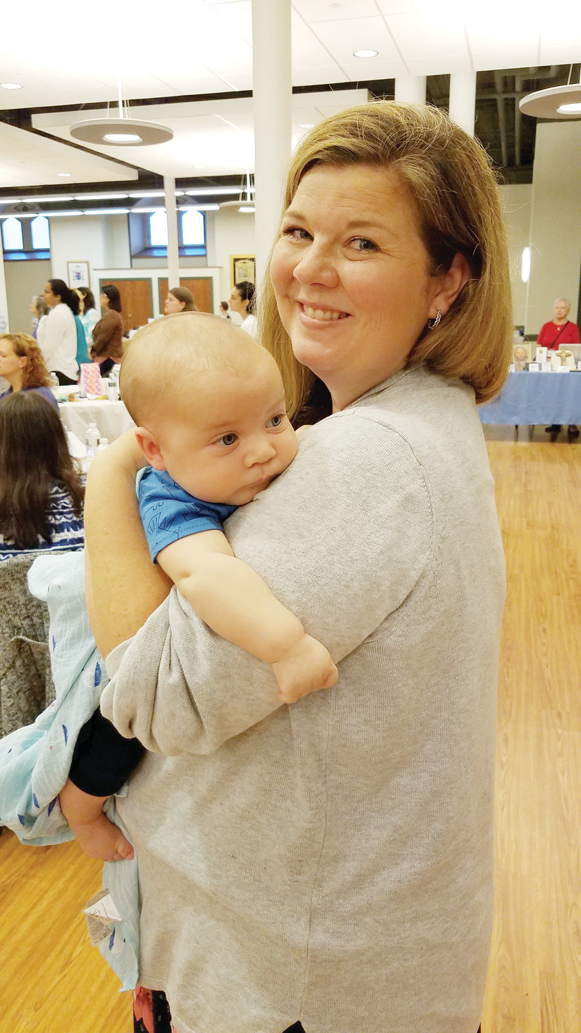 Breanne Trendowski from St. Francis Xavier in Acushnet, Mass., and her baby Silas take part in the annual Rhode Island Women’s Conference.